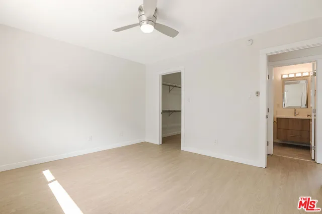 a view of an empty room with a kitchen