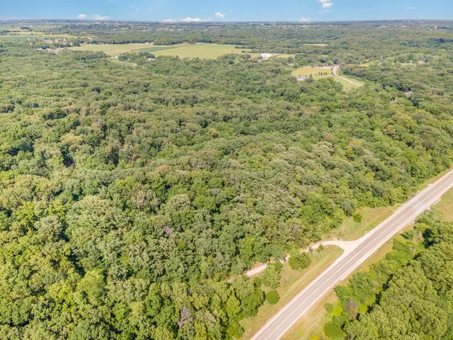 a view of a green field with an outdoor space