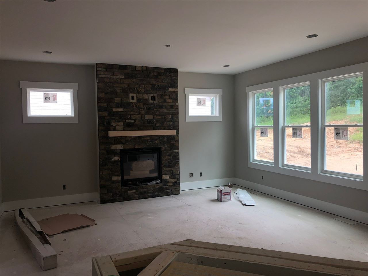 477 Adkins Ridge Road Rolesville, NC 27571 - Photo 6 of 30 Open Family room, stone fireplace with floating wood mantel Family Room