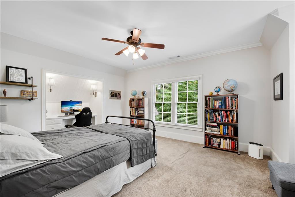 13942 Tree Loft Road Milton, GA 30004 - Photo 57 of 102 a bedroom with a large bed and a book shelf