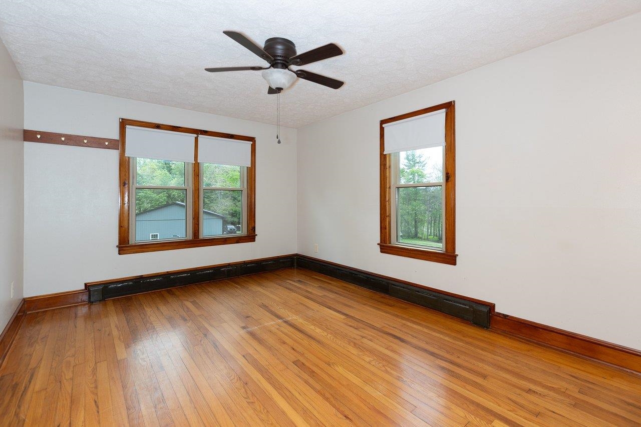 547 Grindstone Road Bridgewater, VA 22812 - Photo 15 of 57 an empty room with wooden floor and windows