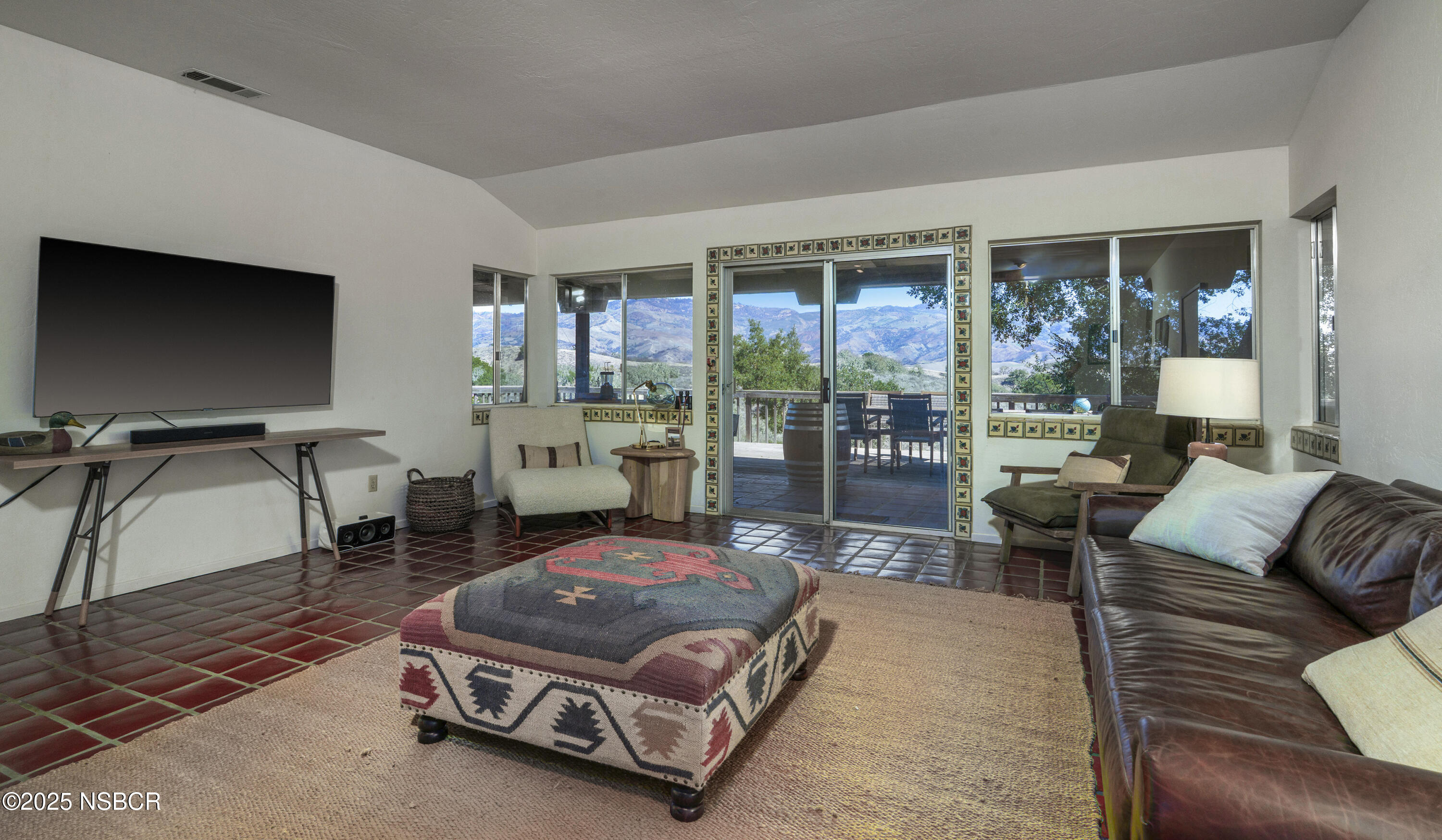 3776 Live Oak Road Santa Ynez, CA 93460 - Photo 12 of 46 a living room with furniture a flat screen tv and a floor to ceiling window