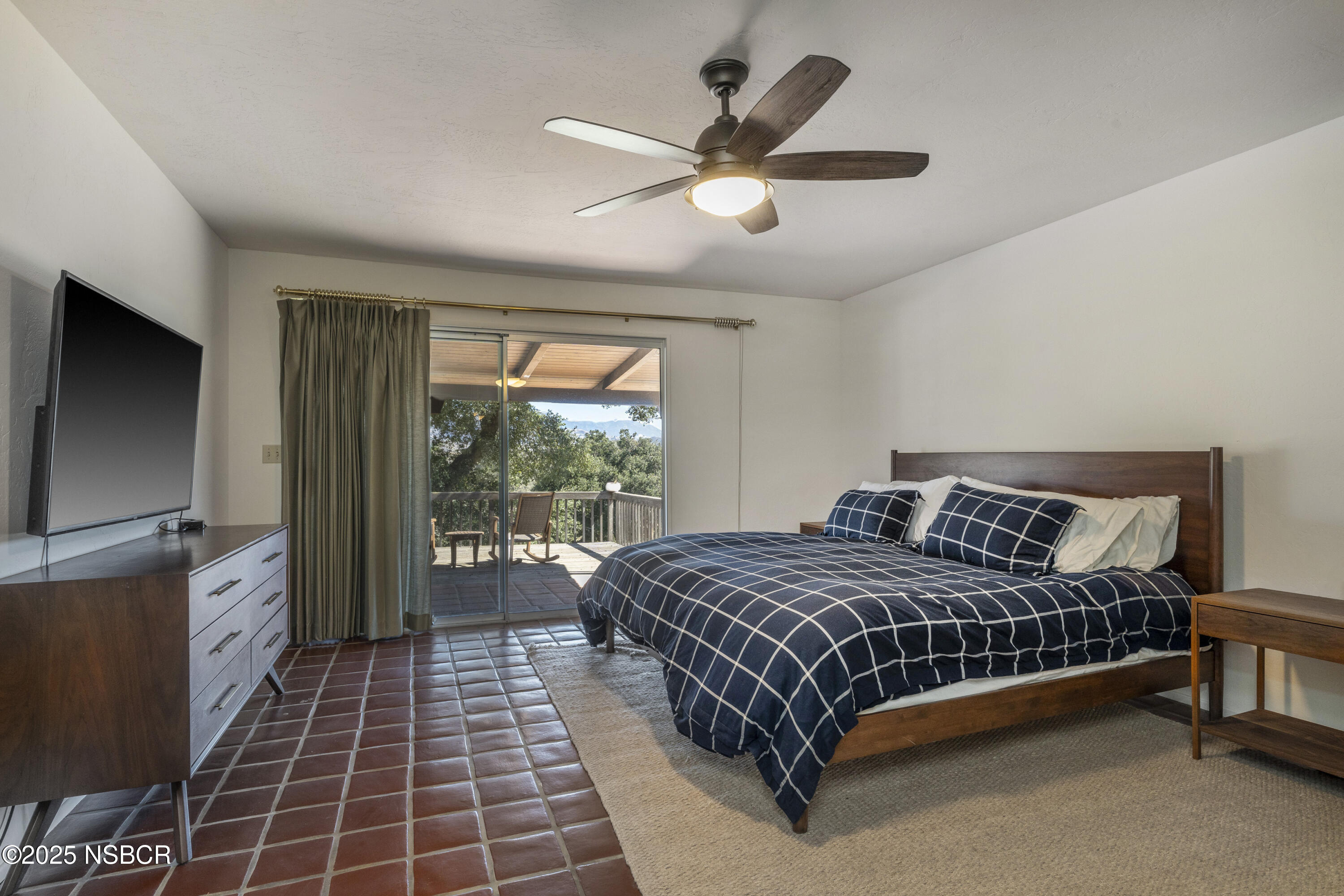 3776 Live Oak Road Santa Ynez, CA 93460 - Photo 17 of 46 a bedroom with a large bed and a flat tv screen on dresser