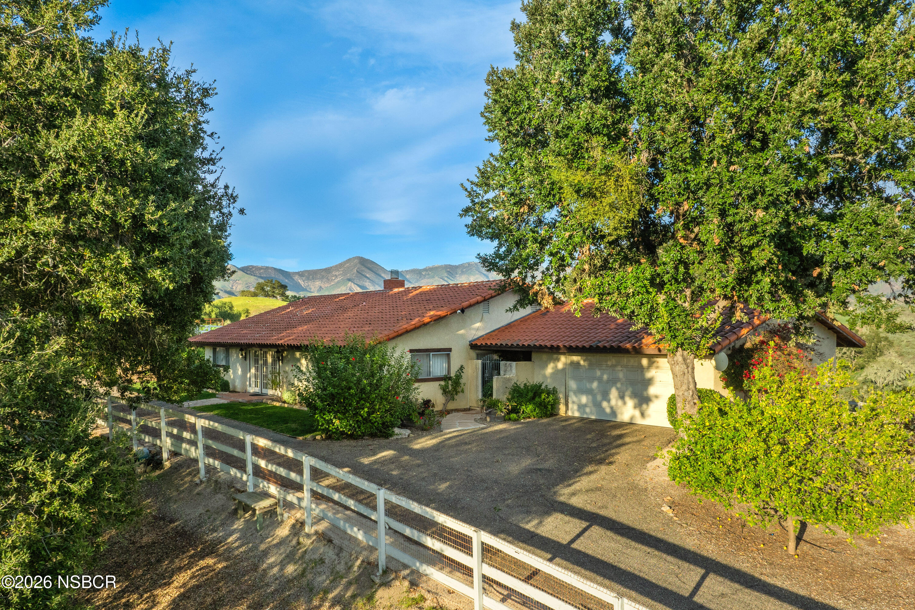 3776 Live Oak Road Santa Ynez, CA 93460 - Photo 4 of 46 a view of a table and chairs under an umbrella