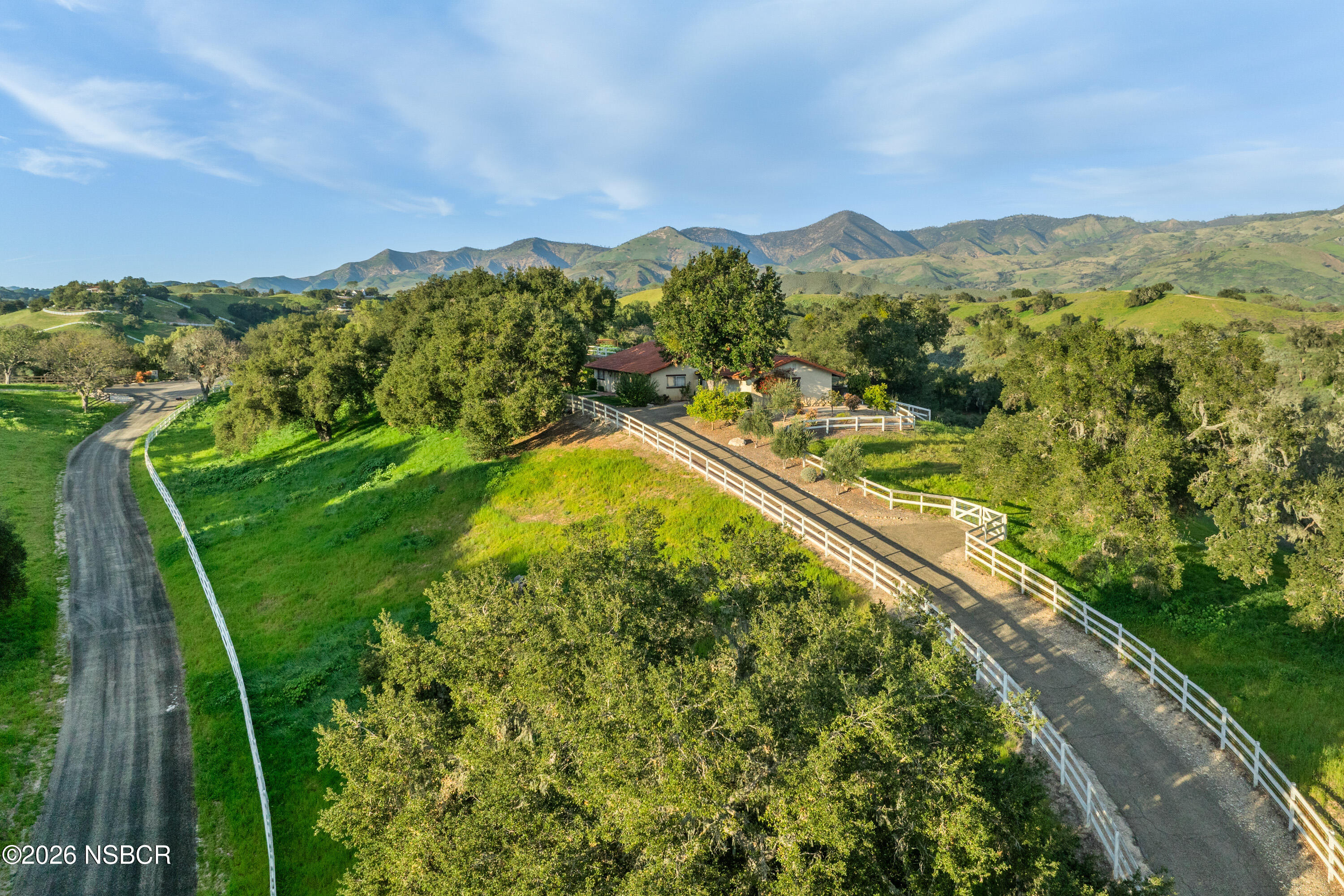 3776 Live Oak Road Santa Ynez, CA 93460 - Photo 6 of 46 a view of a lush green forest with mountains in the background