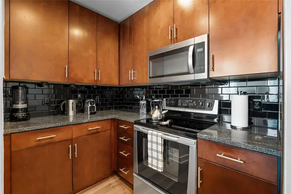 a kitchen with granite countertop a sink and cabinets