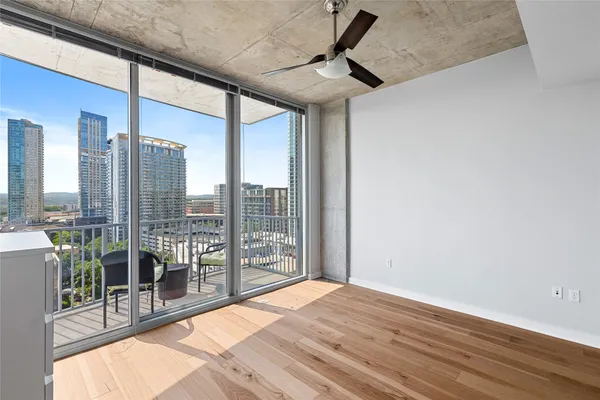 a bedroom with a large bed and a balcony
