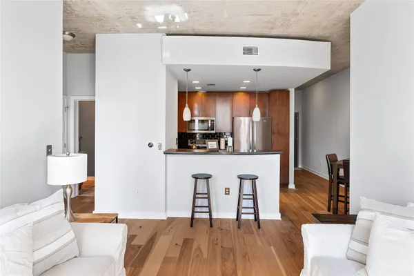 a living room with furniture a flat screen tv and a large window
