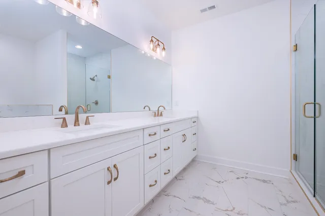 a bathroom with a double vanity sink and a mirror