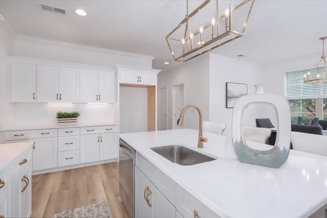 a kitchen with stainless steel appliances granite countertop a sink a stove and cabinets