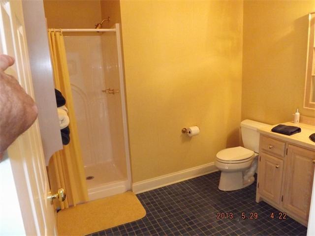 296 Rabbit Trail Road Leoma, TN 38468 - Photo 11 of 15 a bathroom with a granite countertop toilet and a shower
