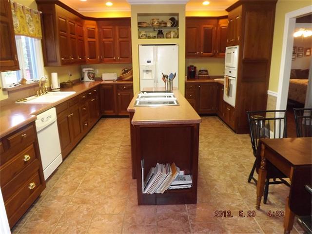 296 Rabbit Trail Road Leoma, TN 38468 - Photo 4 of 15 a kitchen with stainless steel appliances granite countertop a stove a refrigerator and a microwave