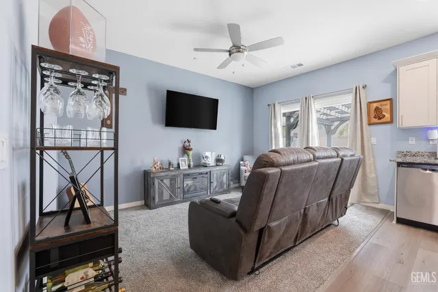 a kitchen with a stove a sink a microwave a dining table and chairs