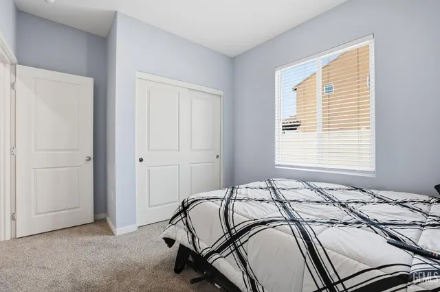 a bedroom with a bed and a lamp