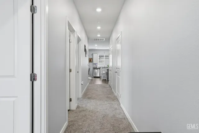 a kitchen with stainless steel appliances kitchen island granite countertop a sink and cabinets