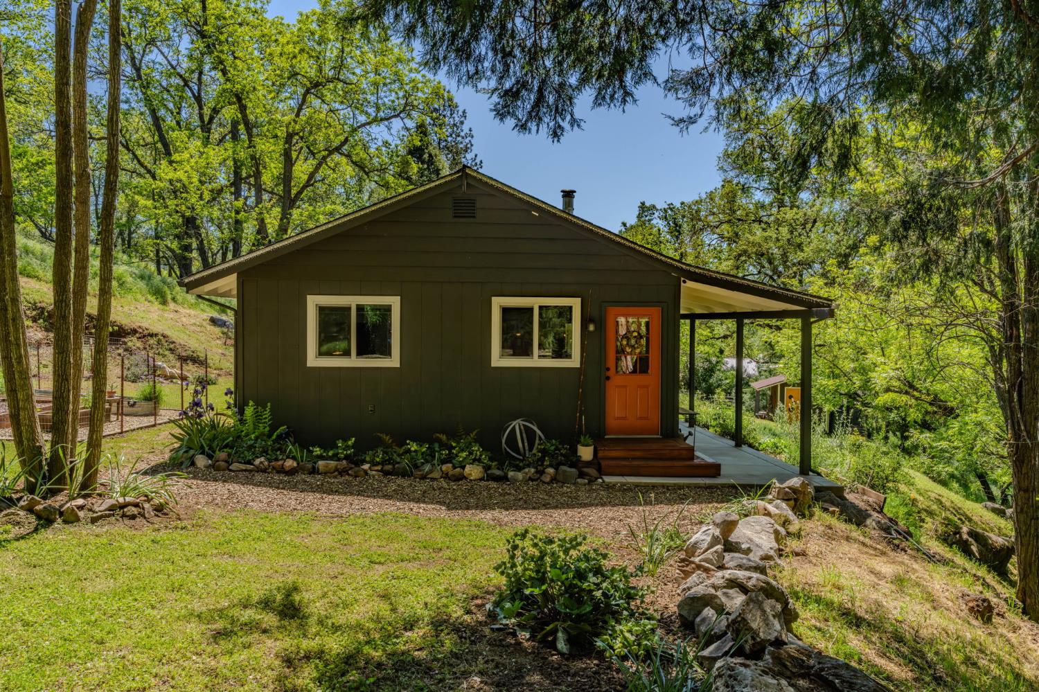 16308 Emigrant Trail Volcano, CA 95689 - Photo 1 of 29 a front view of a house with a yard
