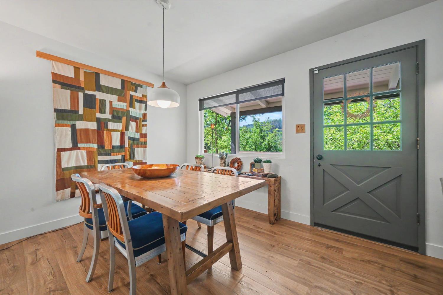 16308 Emigrant Trail Volcano, CA 95689 - Photo 12 of 29 a view of a dining table and chairs in a room