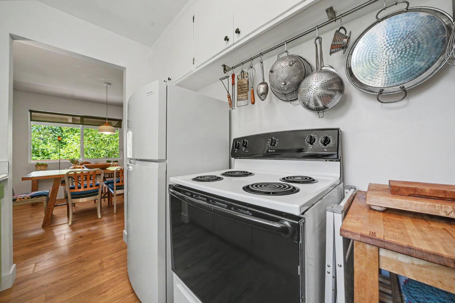 16308 Emigrant Trail Volcano, CA 95689 - Photo 16 of 29 a kitchen with a stove and a table with wooden floor