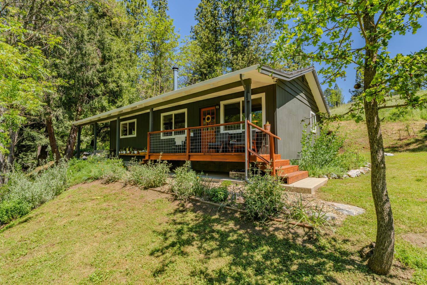 16308 Emigrant Trail Volcano, CA 95689 - Photo 2 of 29 a view of a house with backyard and garden