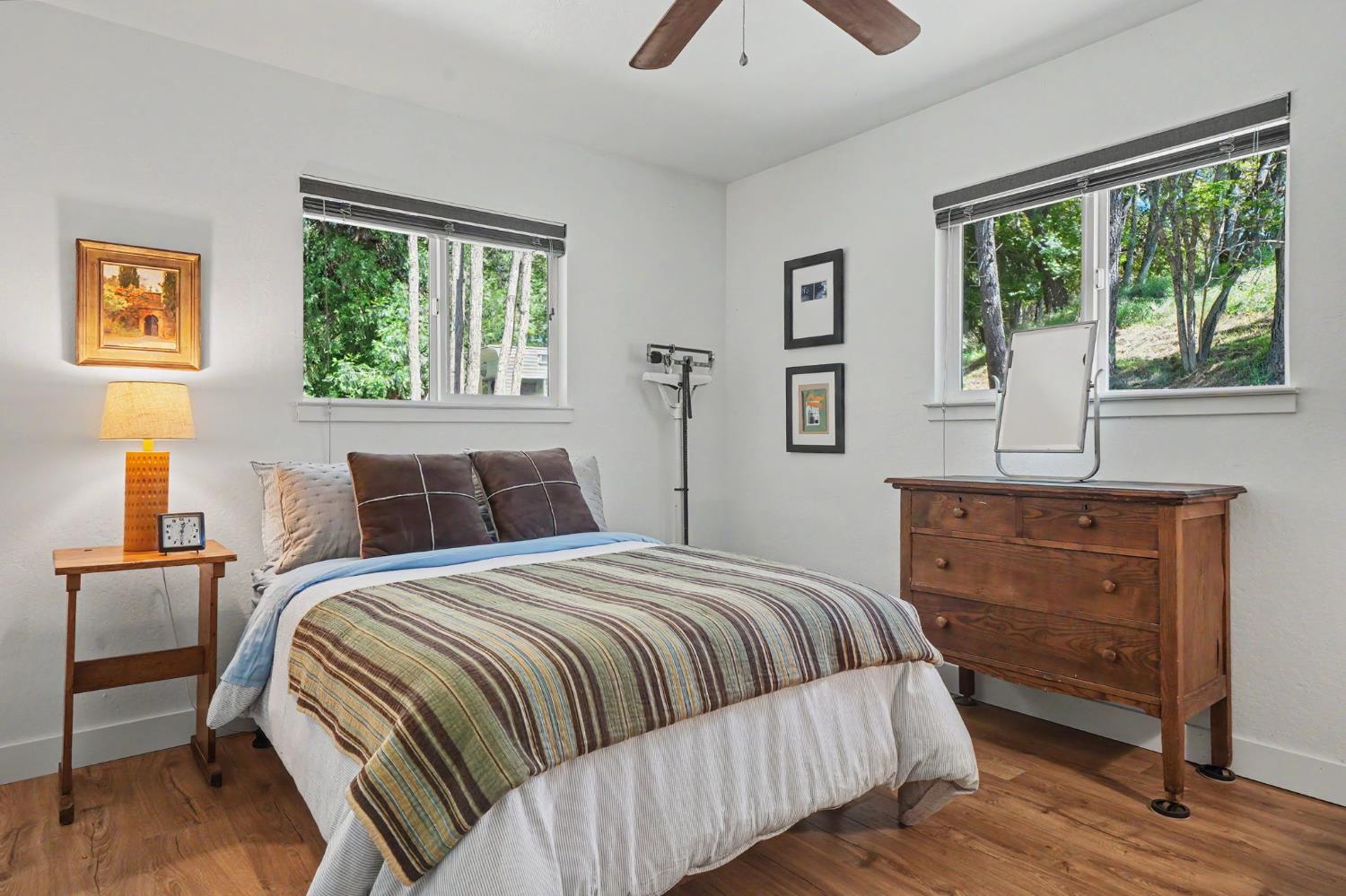 16308 Emigrant Trail Volcano, CA 95689 - Photo 21 of 29 a bedroom with a bed and a dresser next to a window