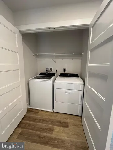 a view of a room with wooden floor and window