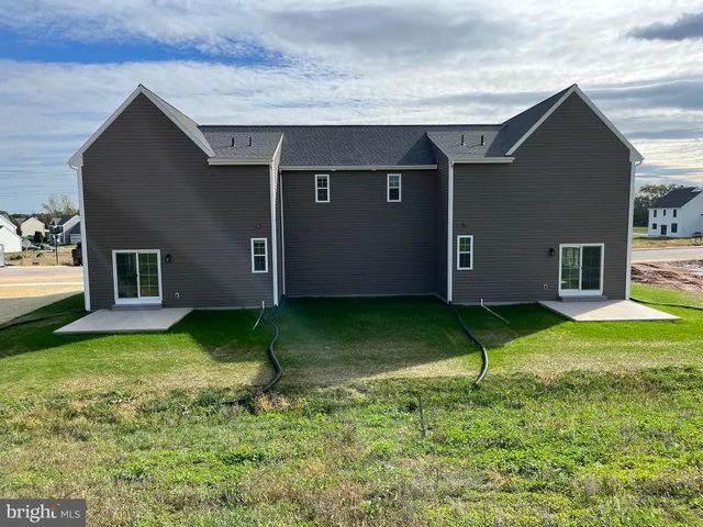 a backyard of a house with plants and pool