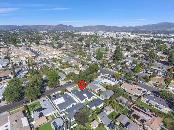 an aerial view of residential houses with city view
