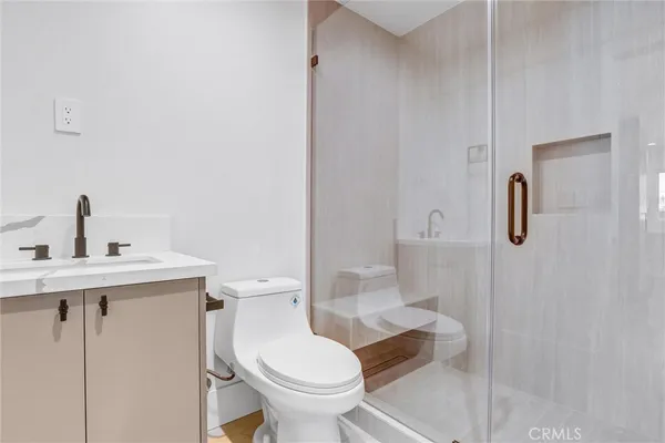 a bathroom with a toilet sink and shower