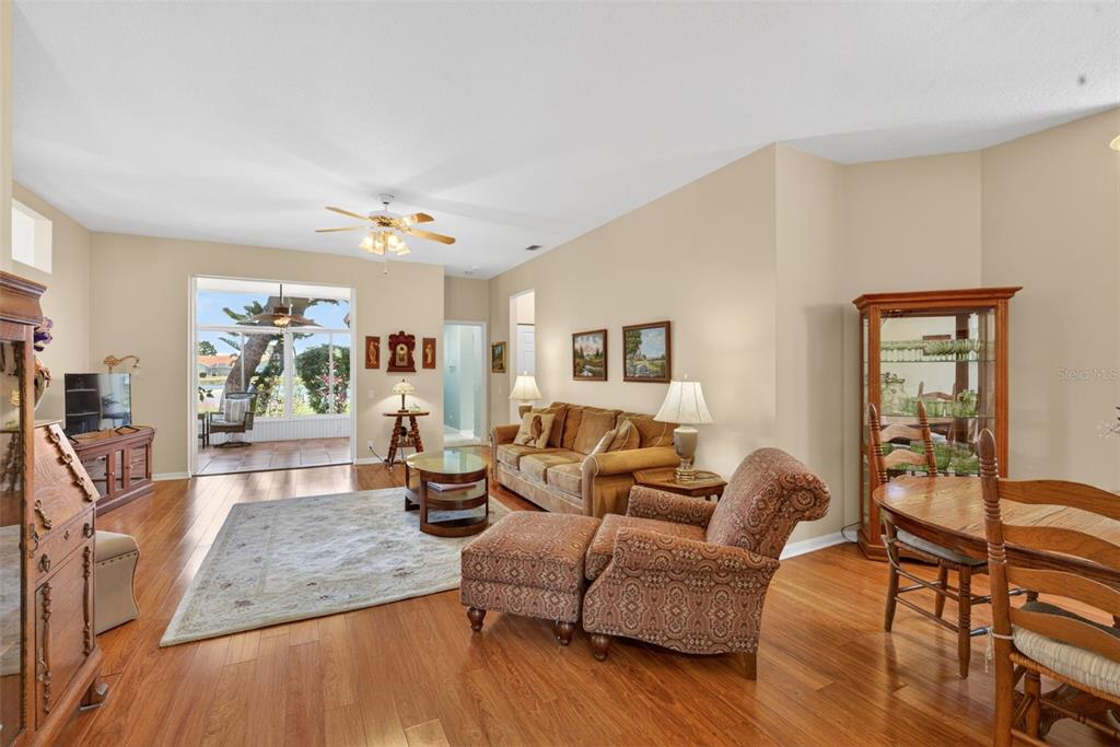 4266 Summertree Road Venice, FL 34293 - Photo 9 of 64 a living room with furniture and wooden floor