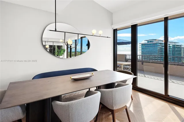 a view of a hallway to a livingroom with furniture and window