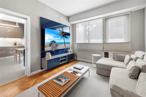 a bedroom with a bed and a flat tv screen on dresser