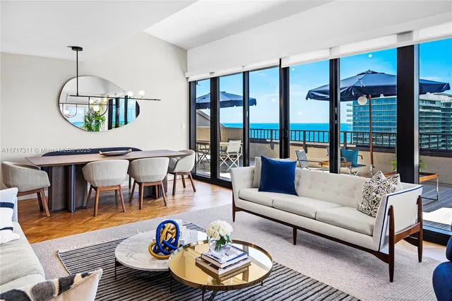 a living room with furniture and a floor to ceiling window