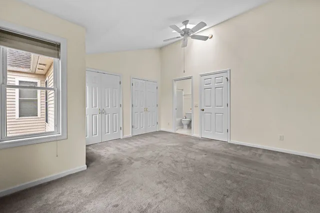 an empty room with windows and closet