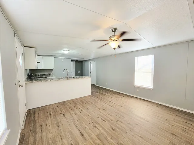 a view of kitchen with wooden floor and window