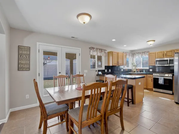 a view of a dining room with furniture and a kitchen