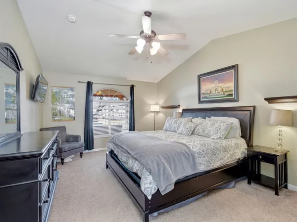 a bedroom with a bed and a chandelier