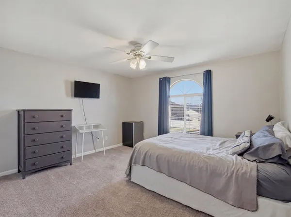 a bedroom with a bed and a dresser