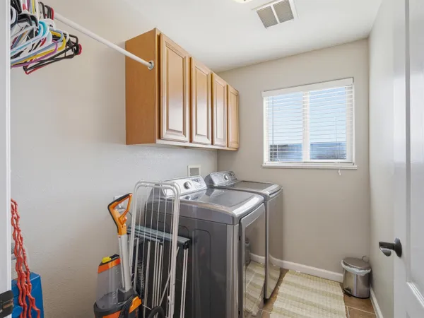 a utility room with sink dryer and washer