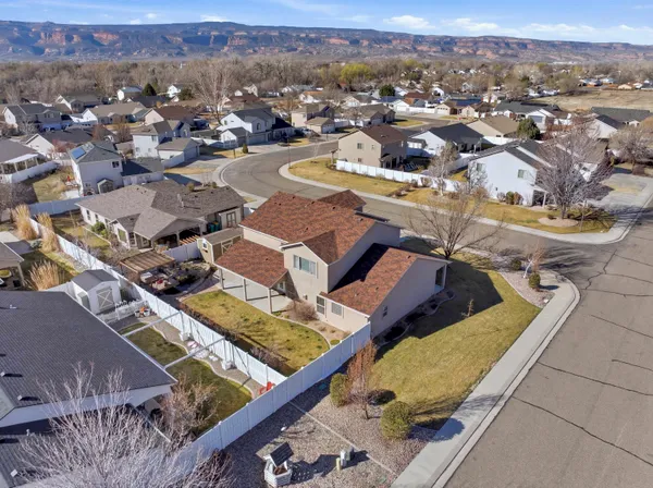 an aerial view of residential houses with outdoor space