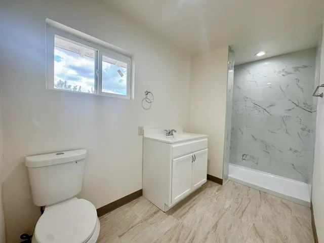 a bathroom with a toilet sink and shower