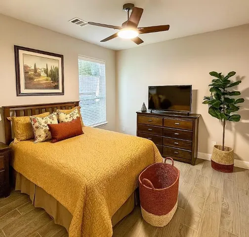 a bedroom with a bed and flat screen tv