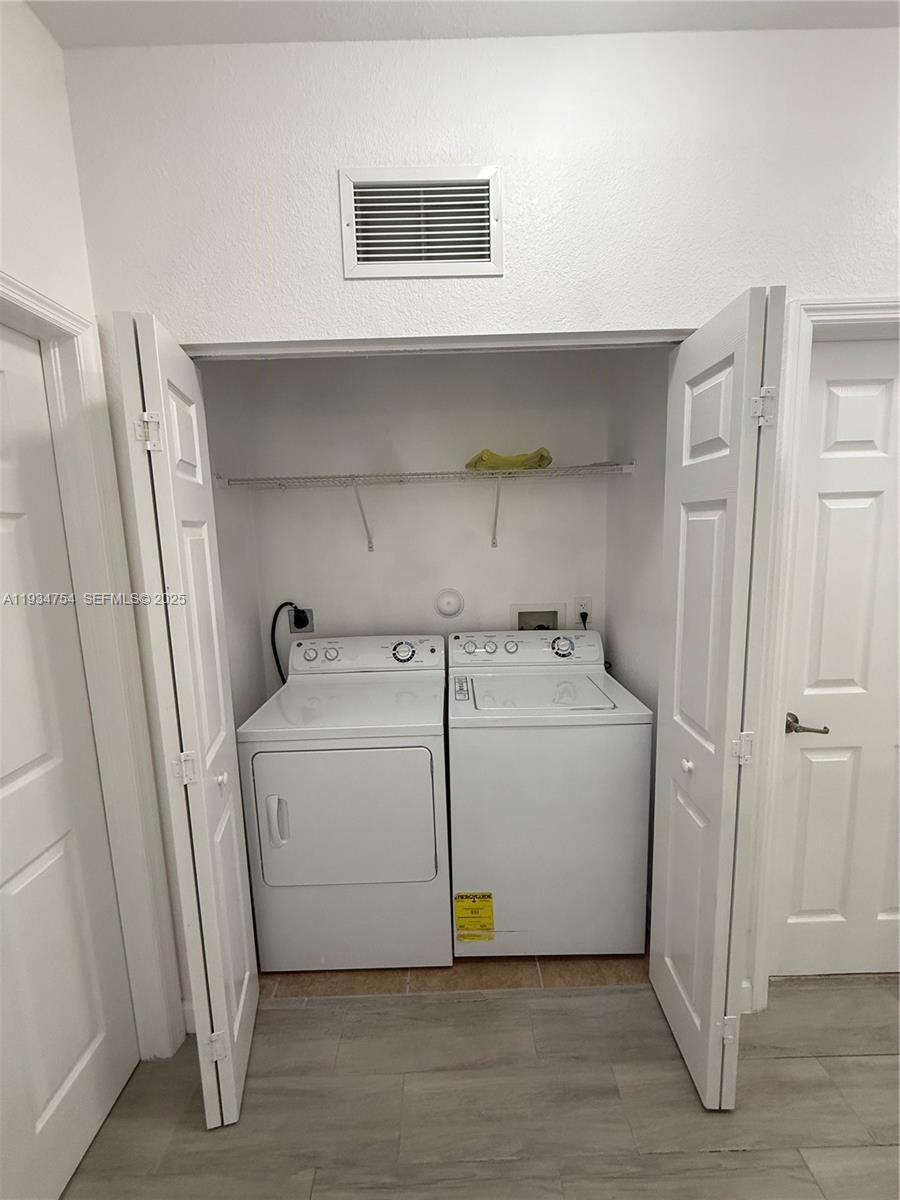9248 Southwest 170th Place, Unit 9248 Miami, FL 33196 - Photo 17 of 30 a utility room with a washer and dryer