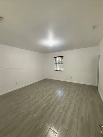 a spacious bathroom with a toilet sink shower and mirror