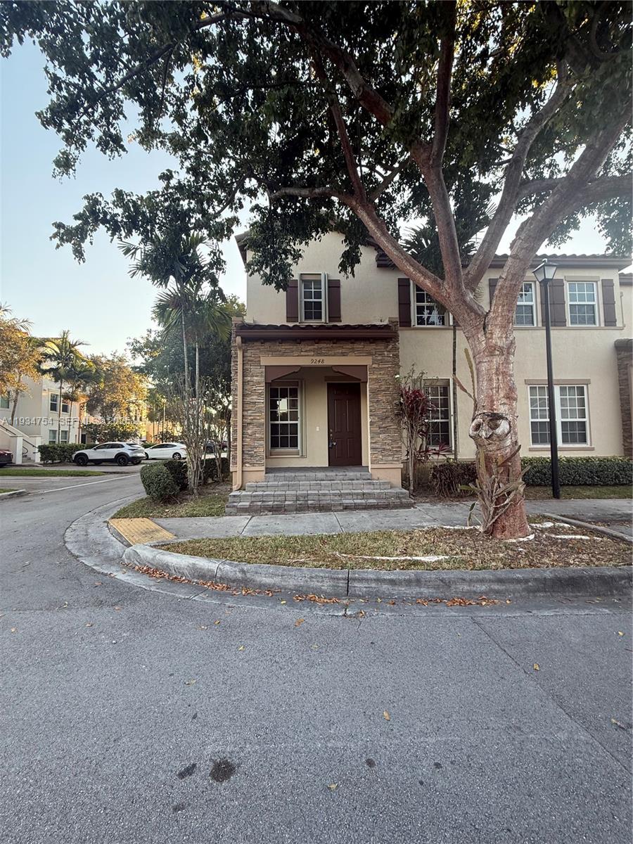 9248 Southwest 170th Place, Unit 9248 Miami, FL 33196 - Photo 2 of 30 a view of road with card parked on side and road
