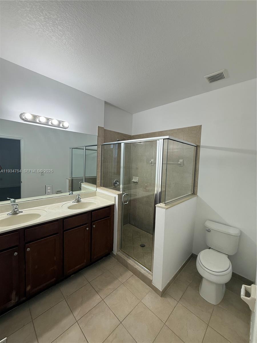 9248 Southwest 170th Place, Unit 9248 Miami, FL 33196 - Photo 21 of 30 a spacious bathroom with a toilet sink shower and mirror