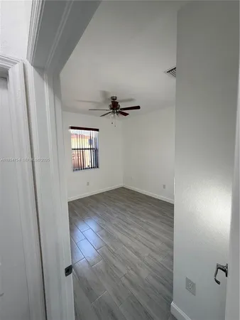 a view of wooden floor and windows in an empty room