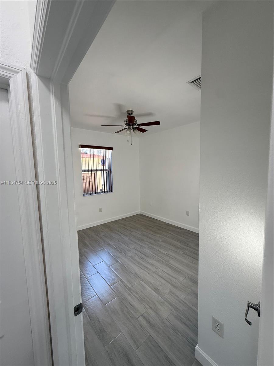 9248 Southwest 170th Place, Unit 9248 Miami, FL 33196 - Photo 26 of 30 wooden floor in an empty room with a window