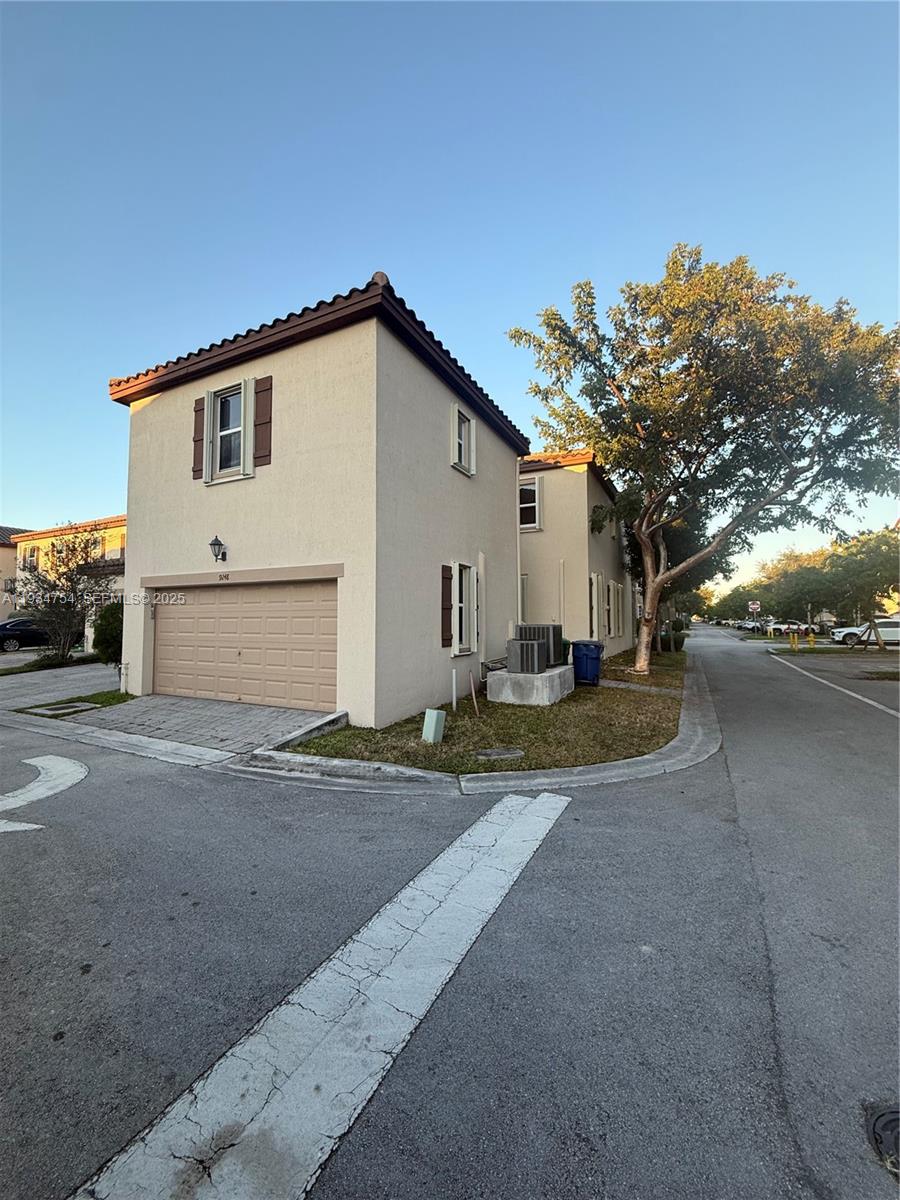 9248 Southwest 170th Place, Unit 9248 Miami, FL 33196 - Photo 30 of 30 a view of a house with a yard
