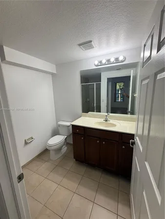 an empty room with a kitchen area and a sink