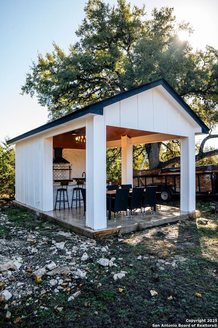 0 Pr 1509 Bandera, TX 78003 - Photo 6 of 8 a backyard of a house with barbeque oven table and chairs